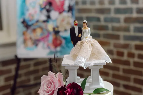 bride and groom wedding topper on top of a wedding cake
